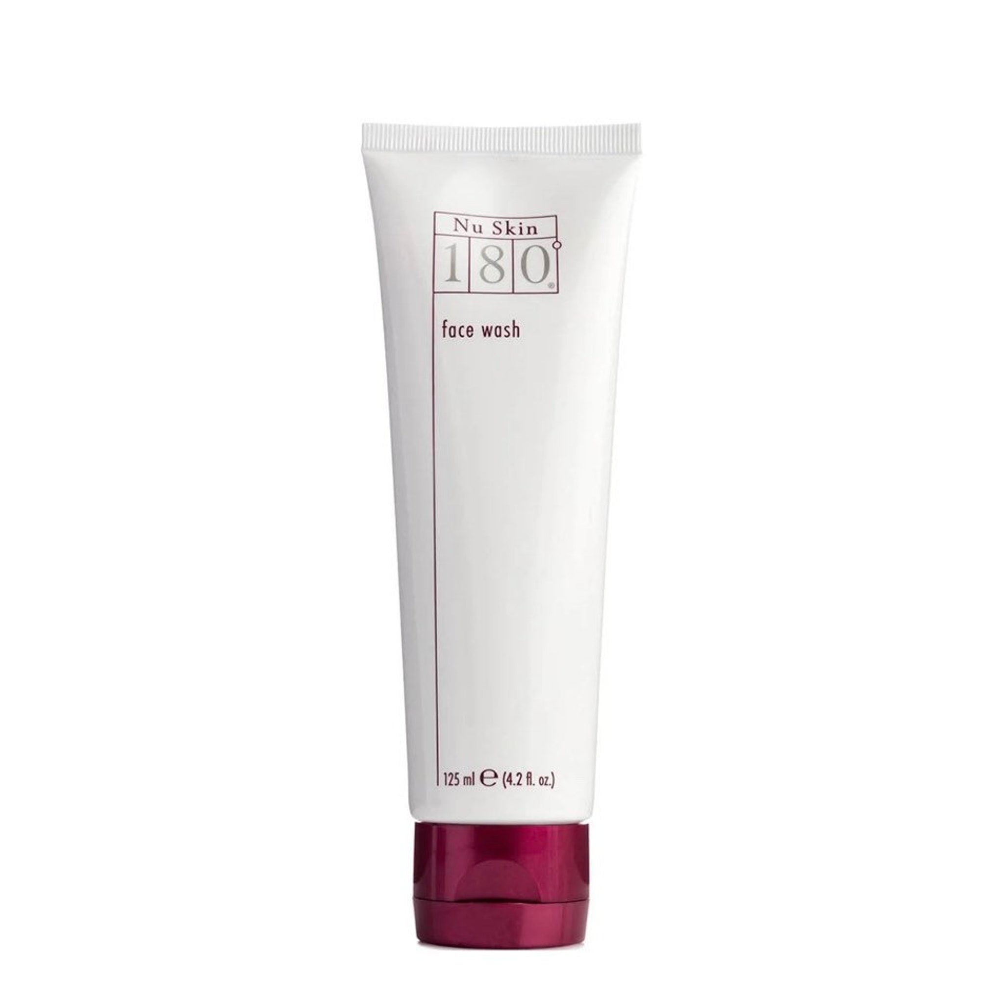 Face wash tube with white body, burgundy cap, and Nu Skin branding