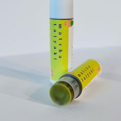 Matcha Lip Balm, green balm with yellow label, white tube with matcha taiyaki text