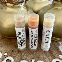 Lip balm tubes in clear, white, and orange, with labels reading "Pumpkin", "Sea Buckthorn", and "Coffee