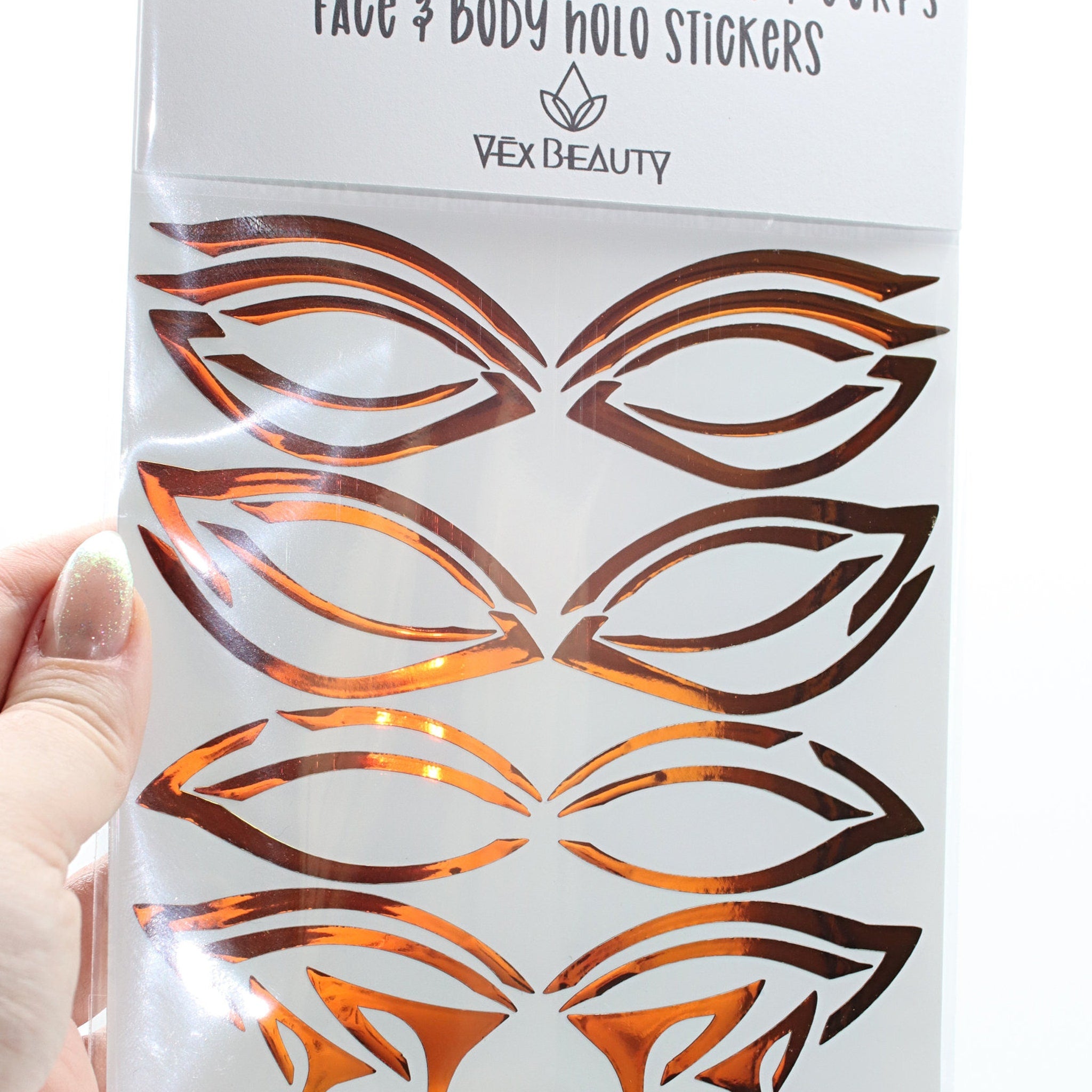 Face and body stickers, orange metallic foil, Vex Beauty brand, eye shape design