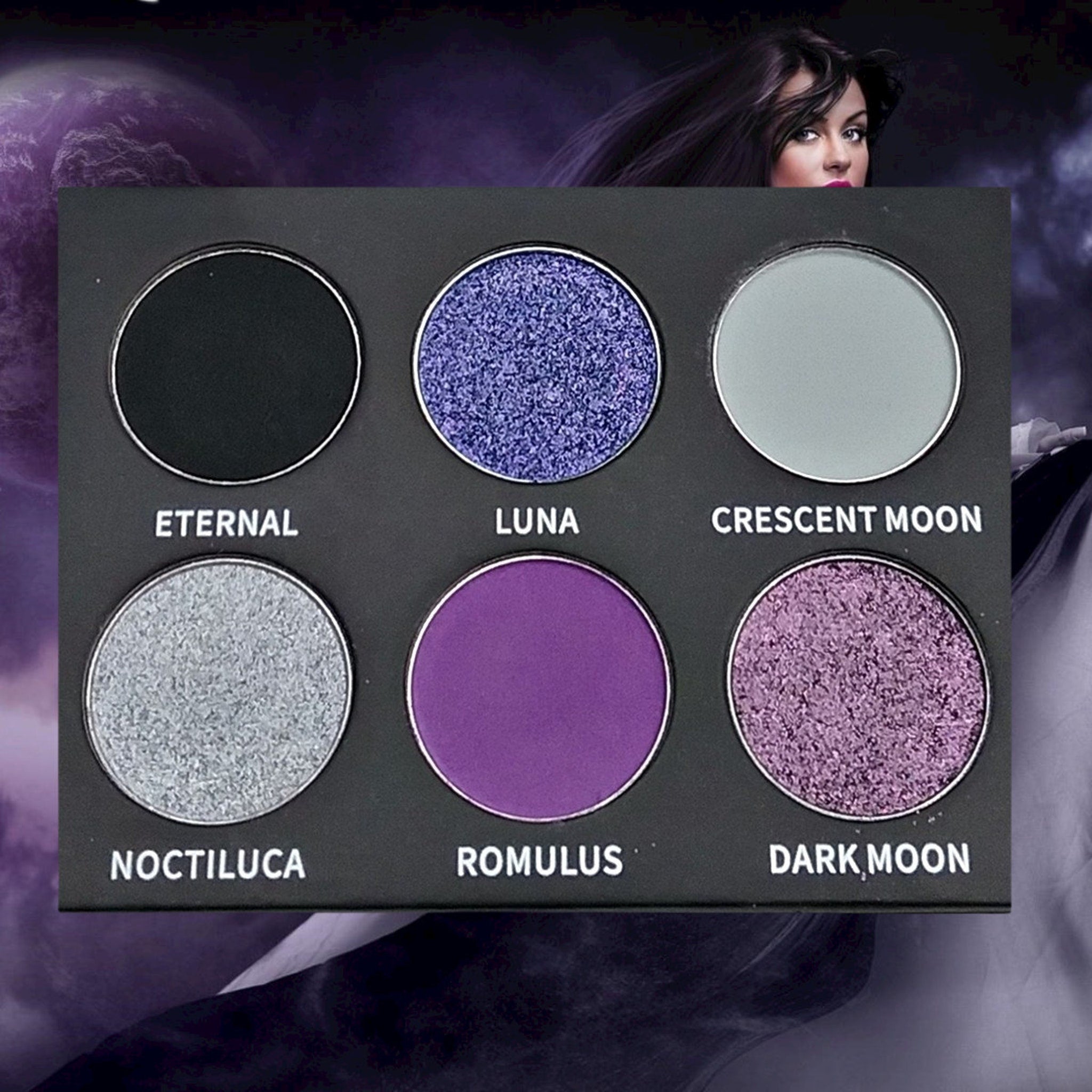 Luna Eyeshadow Palette open on marble surface showing twelve matte and shimmer shades in warm neutrals and bold hues
