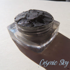 Black shimmer mineral eyeshadow in loose powder form with cosmic sparkle effect, vegan and cruelty-free