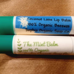Lip balm sticks with blue and white labels, green caps, and text reading "Coconut Lime" and "The Mint
