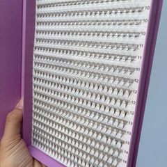 Eyelash extensions, black synthetic lashes on white backing, in purple case with number labels