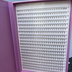 Eyelash extensions in a purple box with black fans and white backing, numbered for length