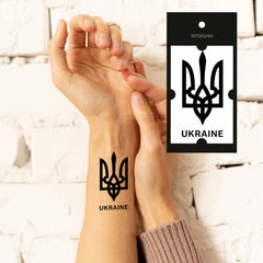 Two temporary tattoo sheets featuring Ukrainian trident designs in blue and yellow, skin-safe for easy application