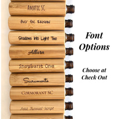 Essential oil roller bottles with bamboo casing and brown glass, various font options displayed