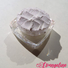 White shimmer loose mineral eyeshadow with green gold sheen in a small round jar
