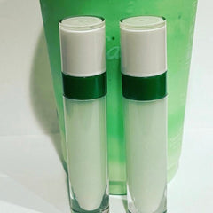 Lip gloss bottles with white, green and clear glass elements, product display
