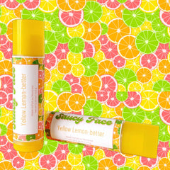 Lip balm tube with yellow and white label, "Saucy Face" text, citrus fruit background
