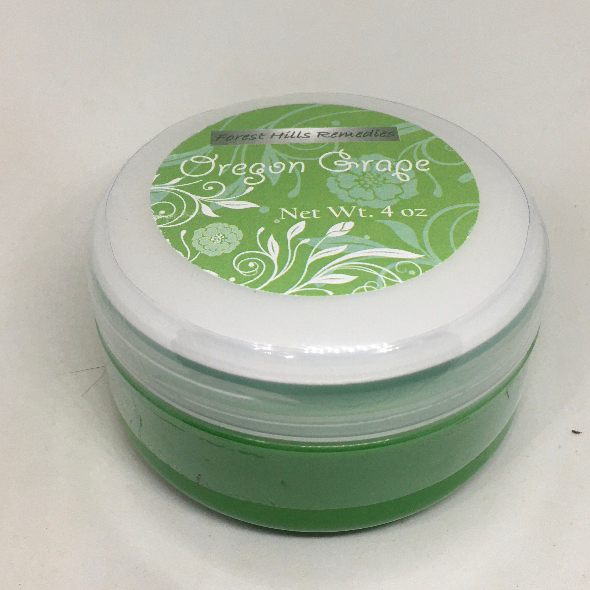 Close-up of golden cream with mahonia aquifolium extract in sleek white jar, showcasing rich texture and natural ingredients