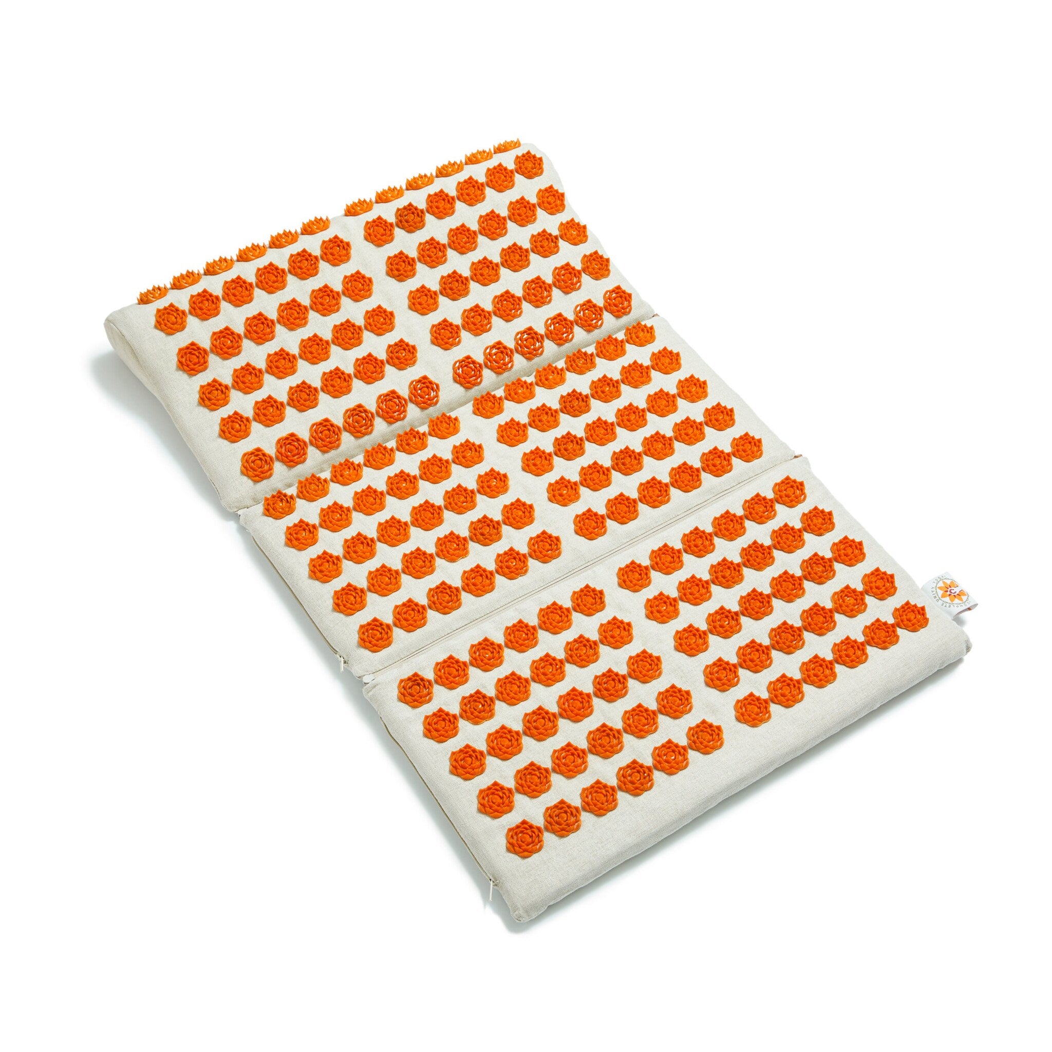 Bath mat with orange flower-shaped nodes on light beige fabric, RelaxFast brand visible