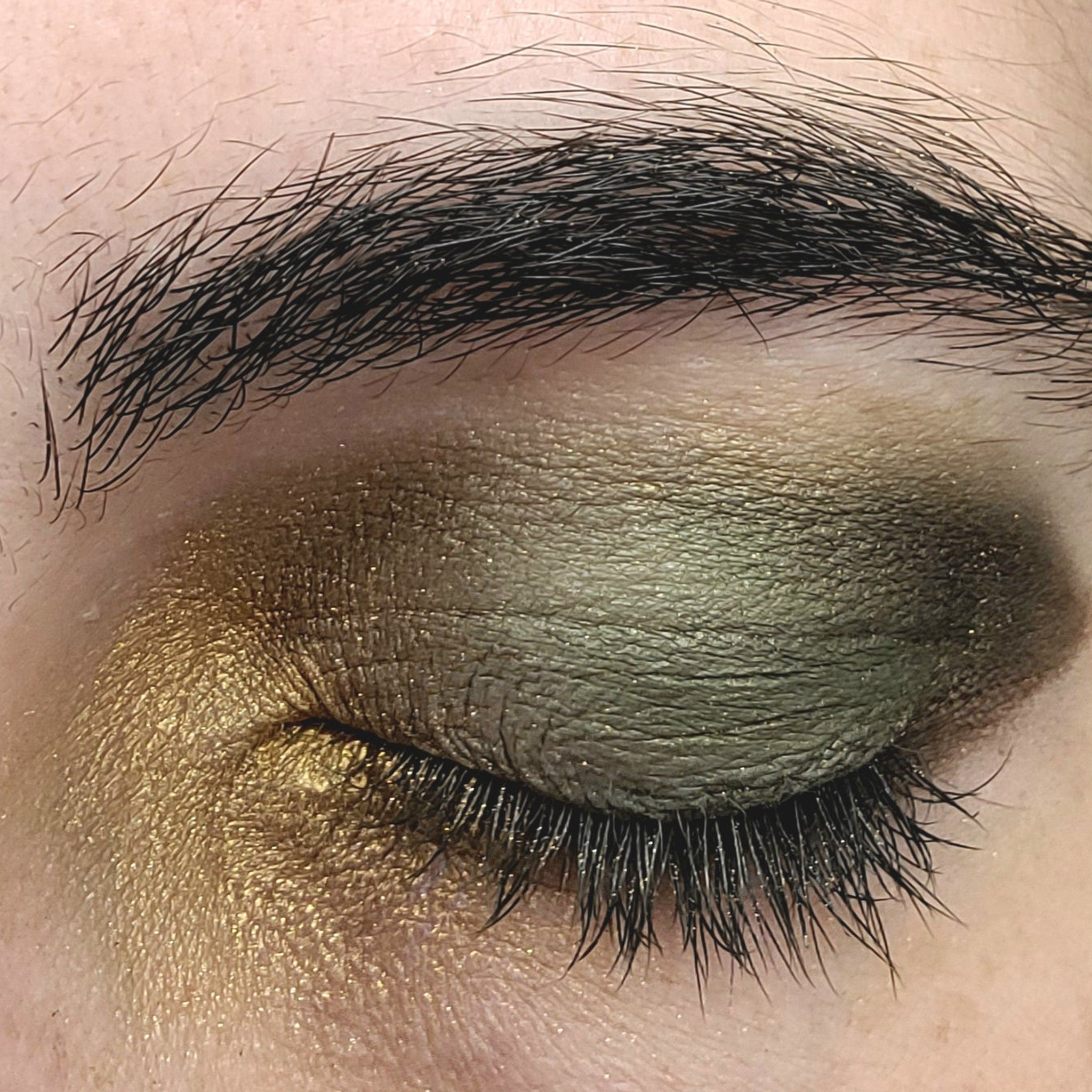 Close-up swatch of espresso brown eye shadow with smooth matte finish on fingertip