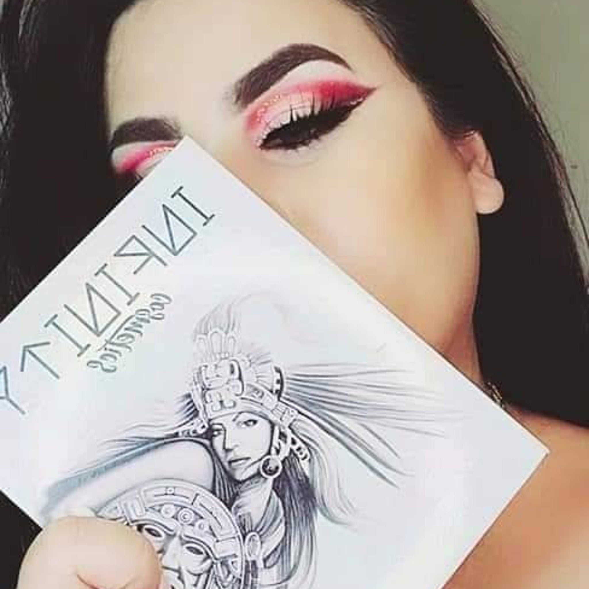 Close-up of shimmering eye shadow palette with bonus dual-ended brush for blending and precise application