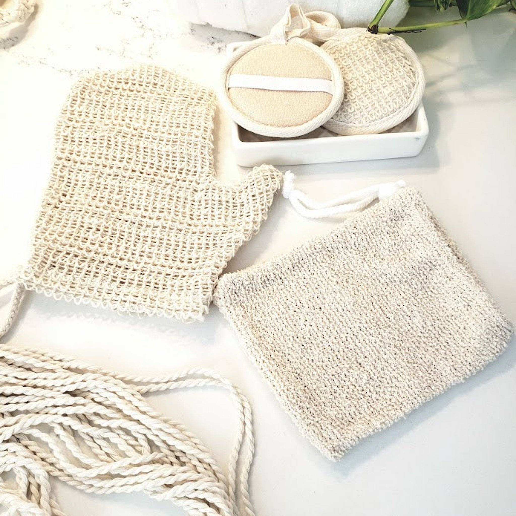 Body scrubbers in beige woven texture with rope ties, spa accessories