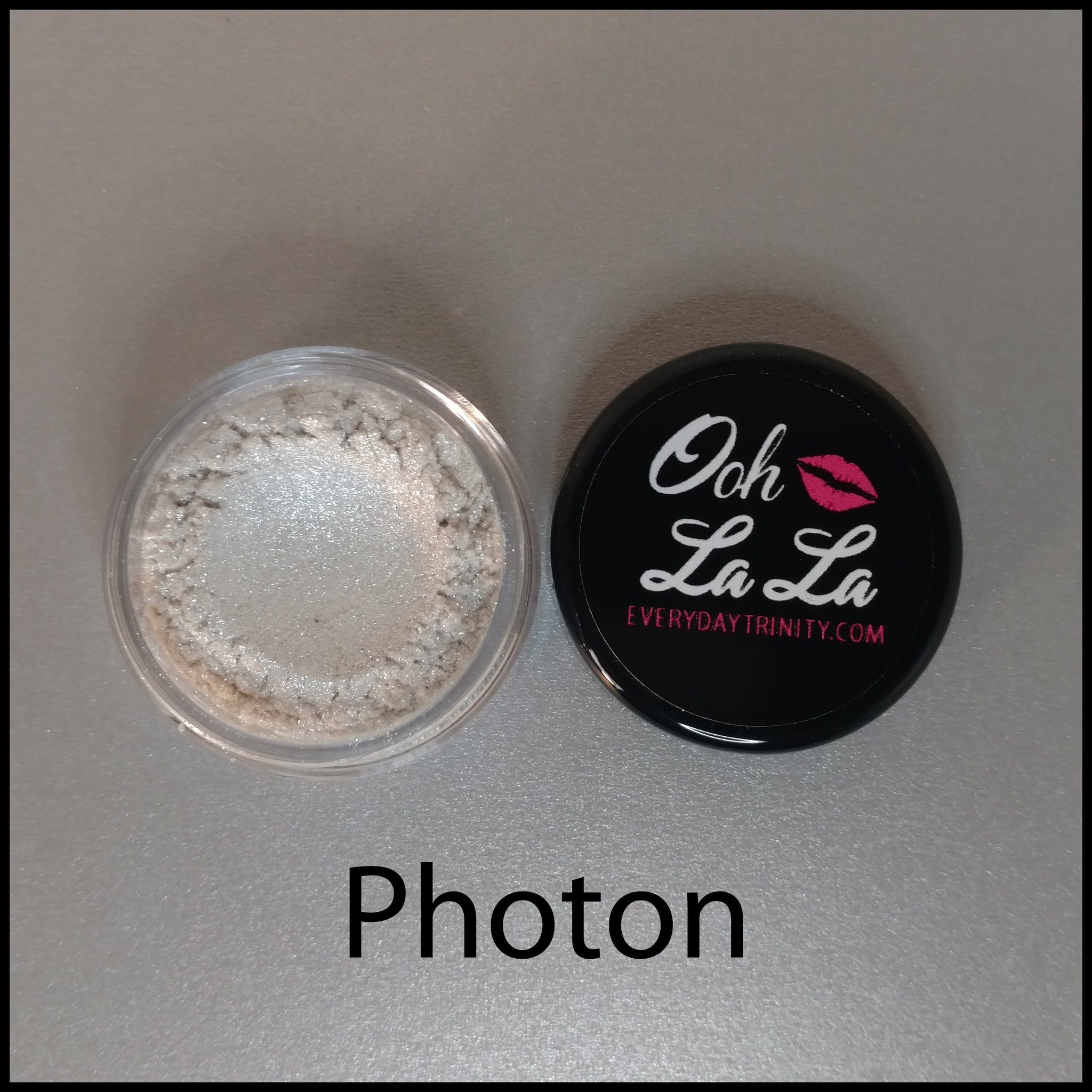 Close-up of white, silver, and black mineral eye shadow powders in a 10g jar with vegan and cruelty-free labels