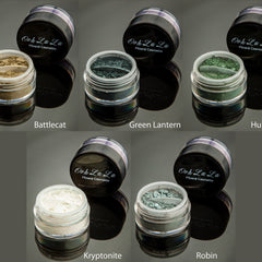 Close-up of matte green vegan mineral eye shadow in compact with gold trim and mirror