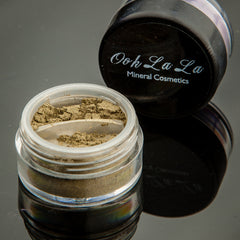 Side view of pressed green mineral eyeshadow palette showing earthy olive and sage tones with matte finish