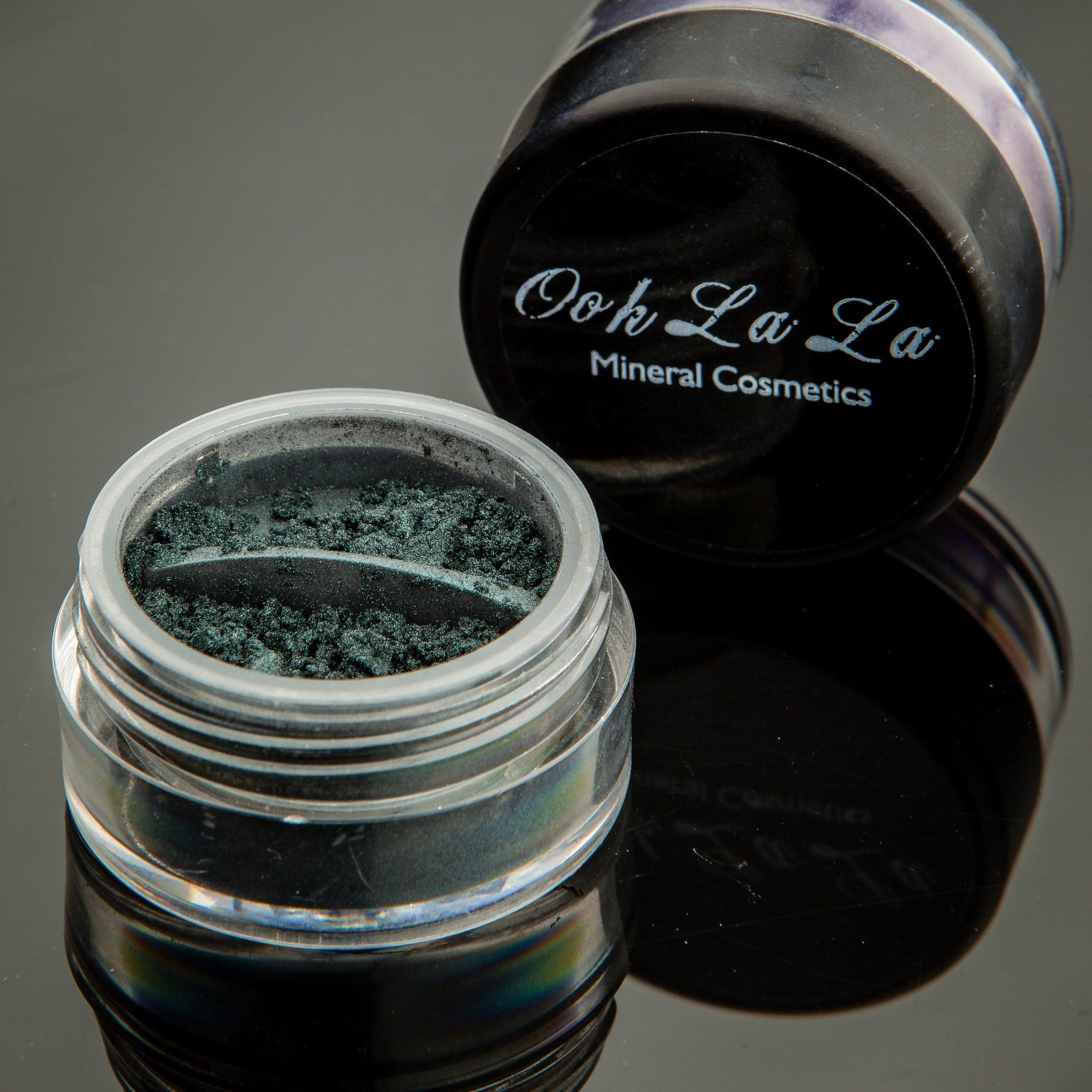 Eco-friendly cardboard packaging for vegan green mineral eyeshadow with ingredient list visible