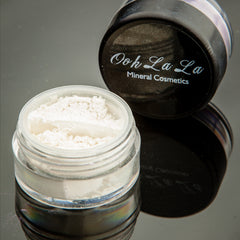 Close-up of matte brown and neutral vegan mineral eye shadow in a sleek 10g jar with visible powder texture