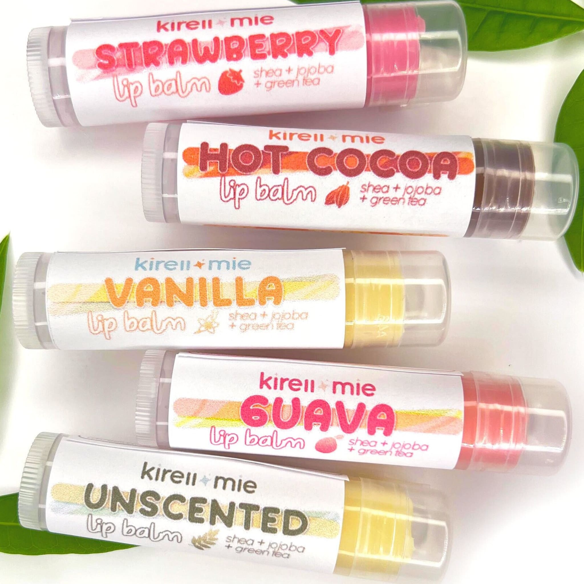 Lip balm tubes with white labels, various colors, Kireiimie brand text visible