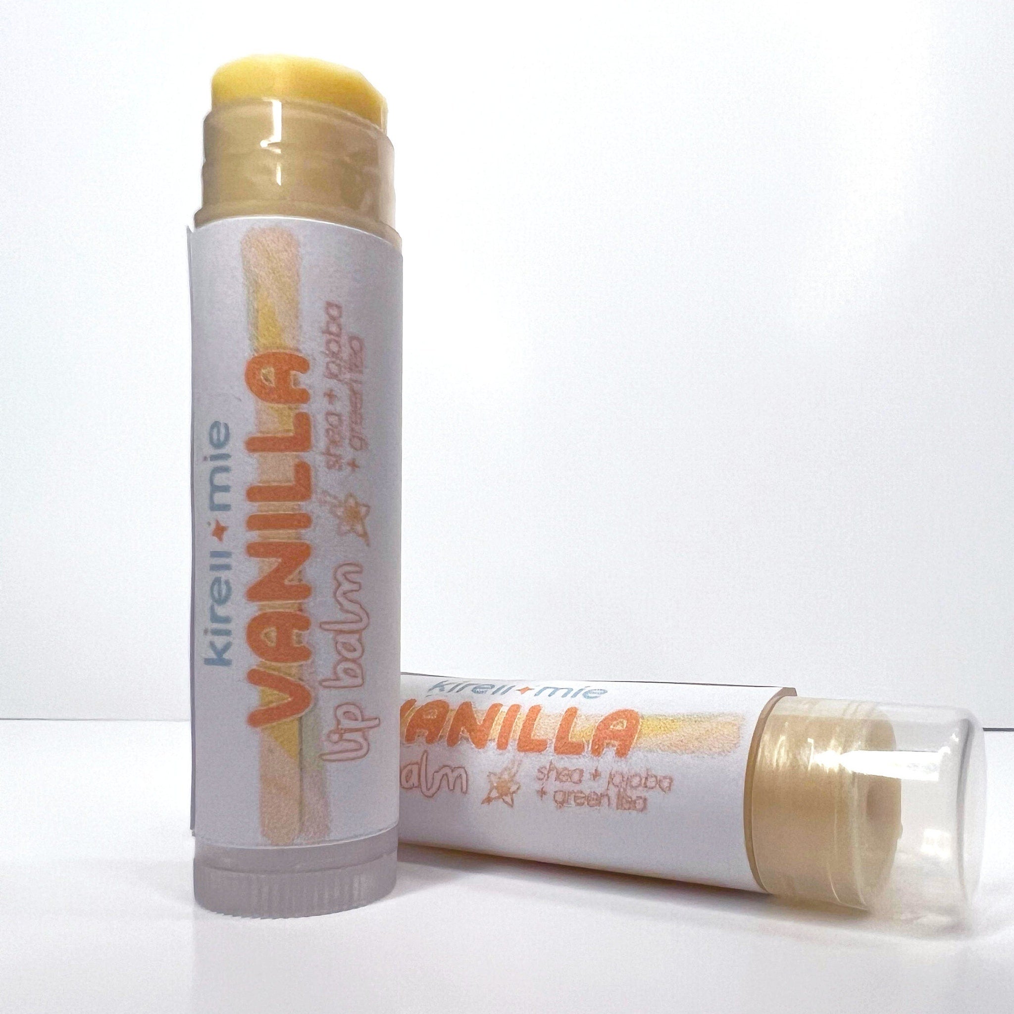 Lip balm tubes with vanilla label, clear plastic cap, and light yellow balm visible