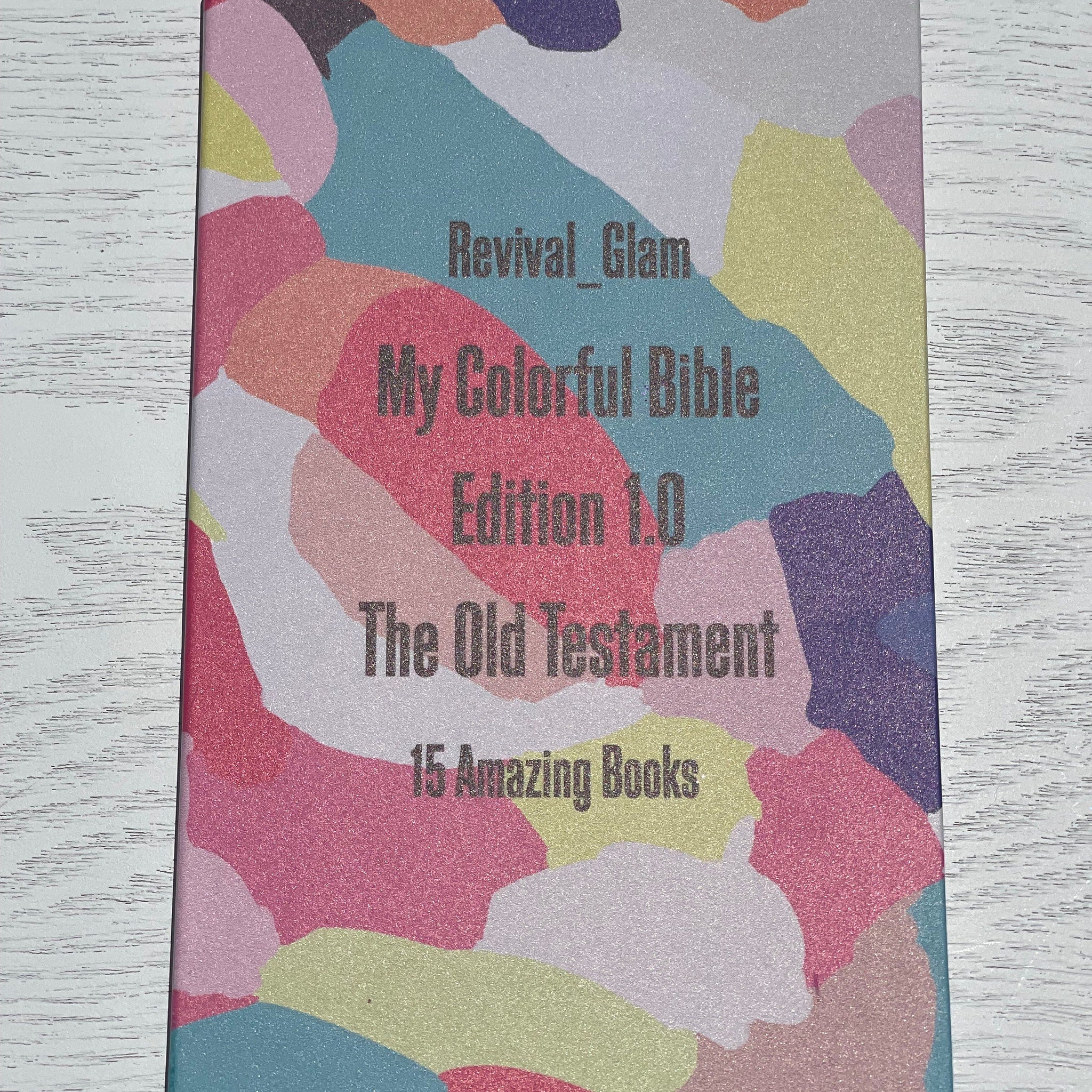 Bible cover with colorful abstract pattern, Revival_Glam text, and The Old Testament title