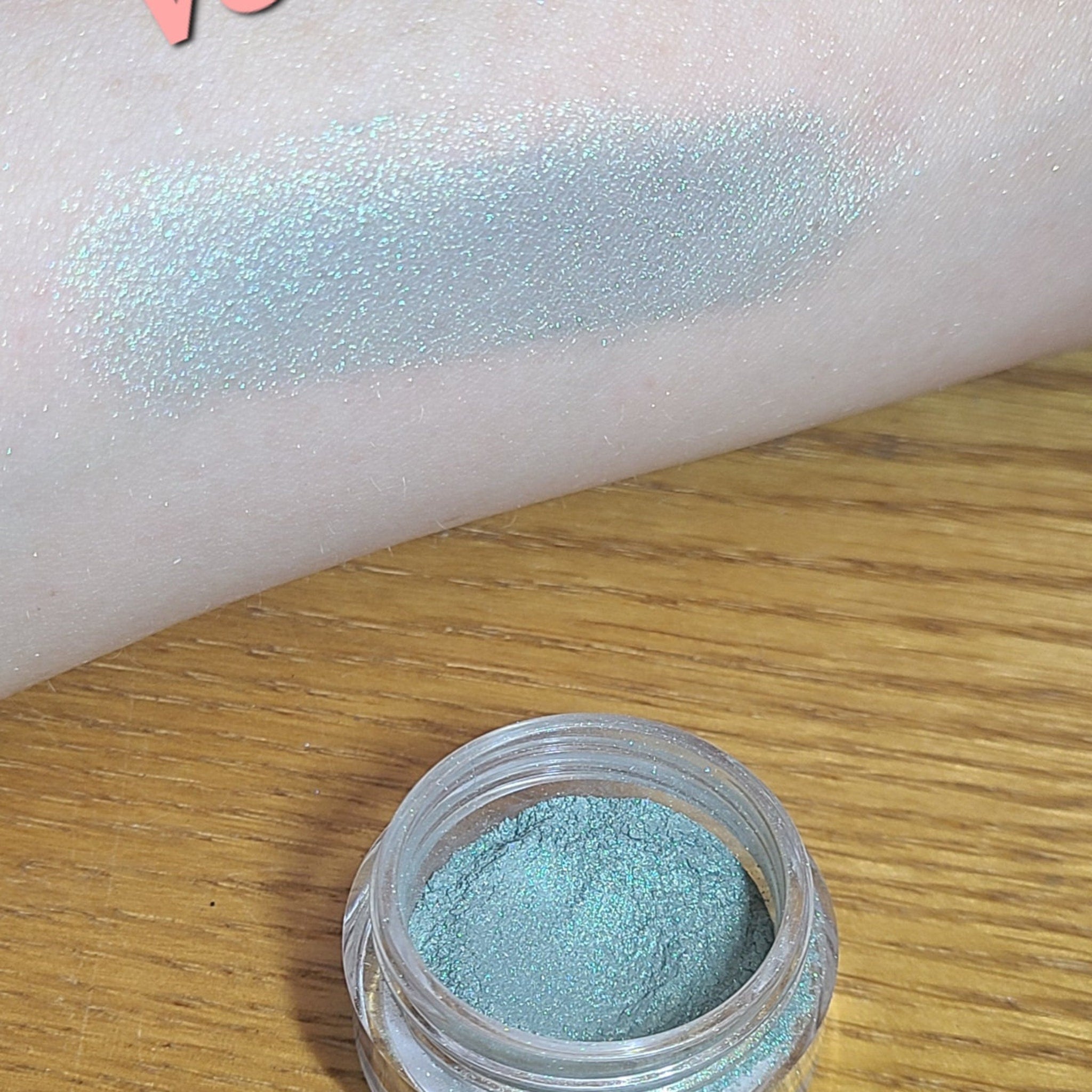 Swatch of natural blue loose eyeshadow on skin with soft shimmer finish