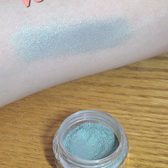 Swatch of natural blue loose eyeshadow on skin with soft shimmer finish