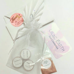 Three small glass jars of vegan mineral eyeshadow in natural shades with matte and shimmer finishes