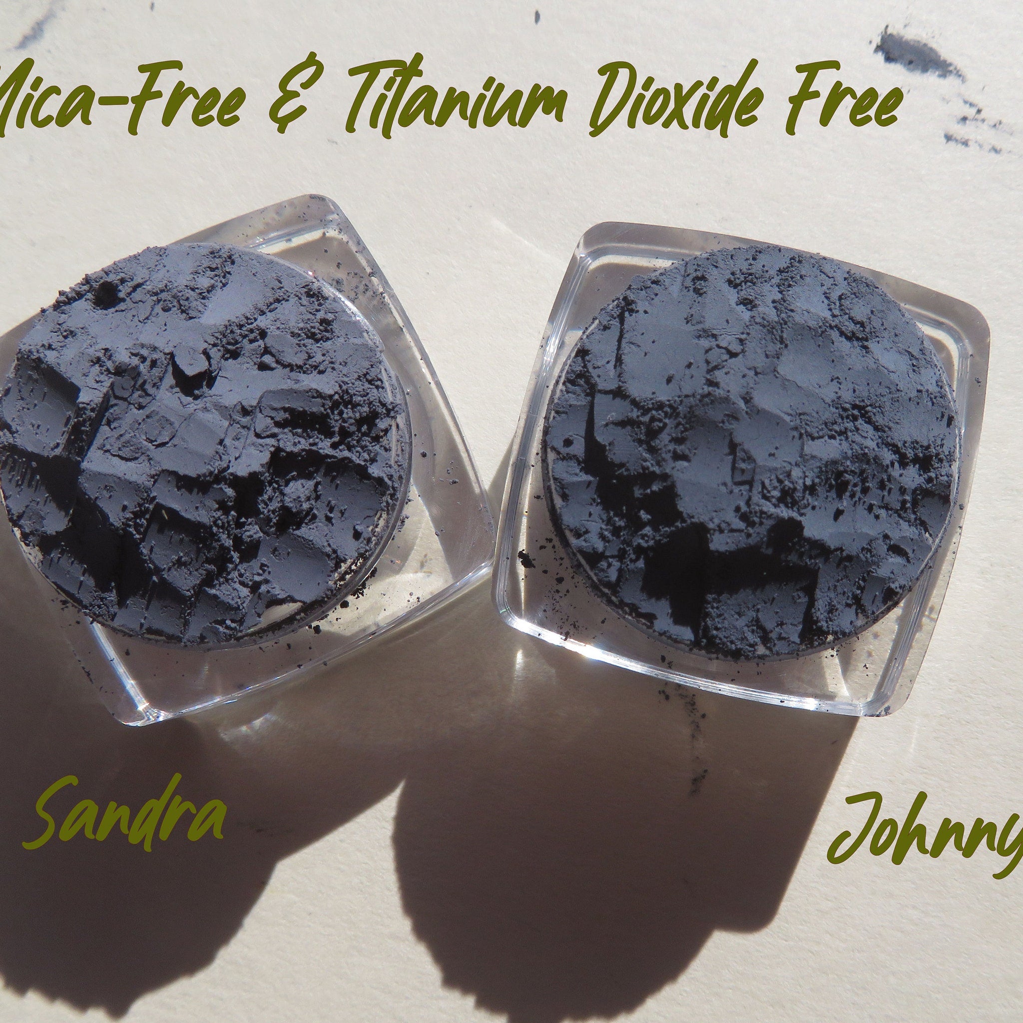 Powder eyeshadow in dark gray color with clear plastic containers, "Sandra" and "Johnny" text visible