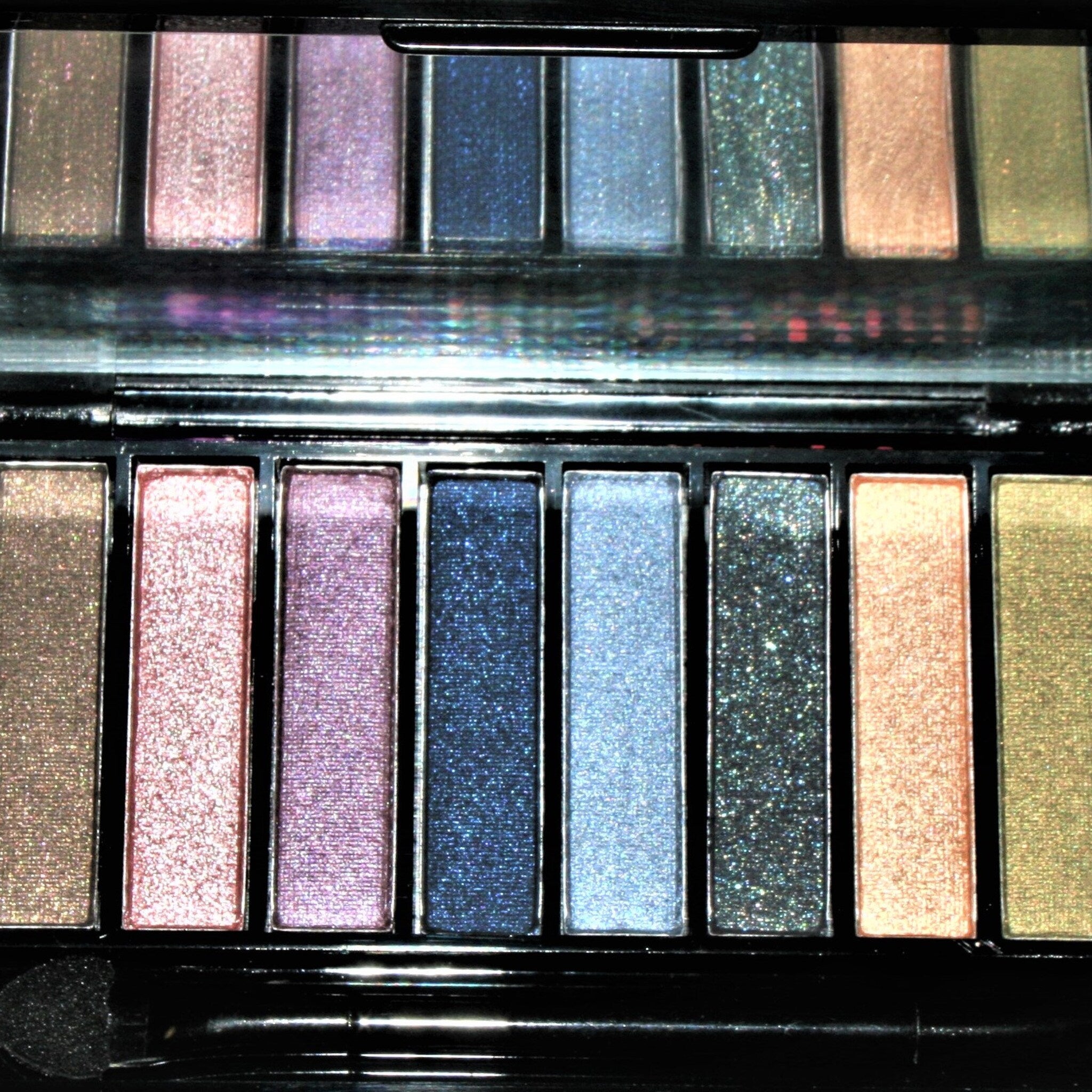 Hand applying shimmery taupe eyeshadow from vintage gold compact with floral detailing