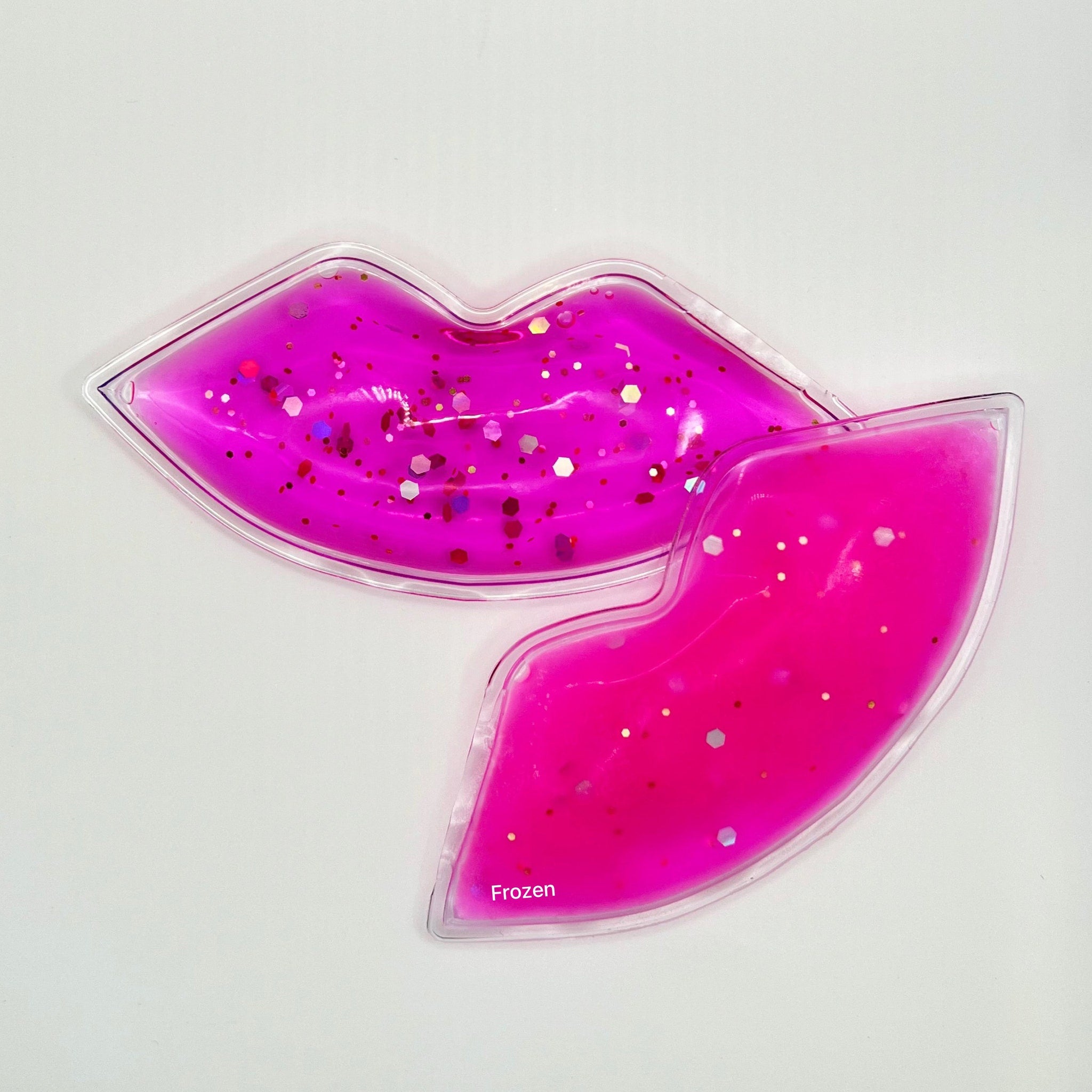 Lip shaped ice pack in pink with glitter, clear border, and "Frozen" text visible.