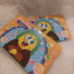 Side view of Pawfect Eyes on Me palette showing 12 vibrant matte and shimmer eyeshadow pans in pet-themed packaging