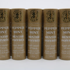 Plant-based lip balm tubes in brown cardboard with gold logo and white text, GLEAM & GLOW brand