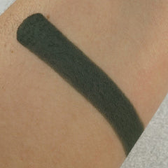 Close-up of matte pressed eyeshadow pan in tropical blue shade with smooth texture and crisp edges