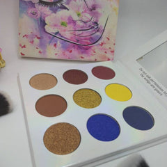 Close-up of shimmering bronze and taupe eye shadow palette with smooth, blendable powder textures