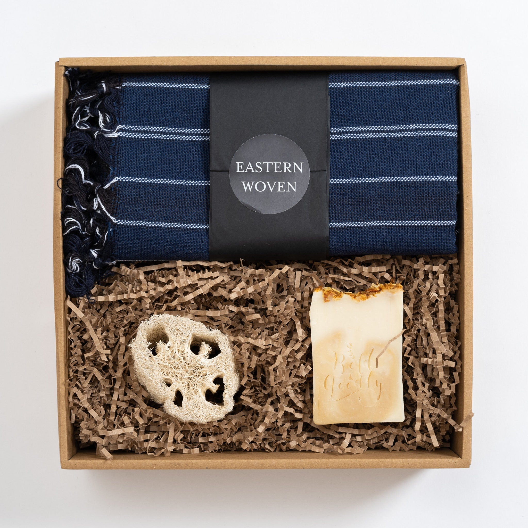 Gift set with blue striped towel, natural soap, and loofah in a cardboard box, Eastern Woven brand