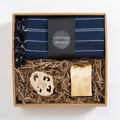 Gift set with blue striped towel, natural soap, and loofah in a cardboard box, Eastern Woven brand