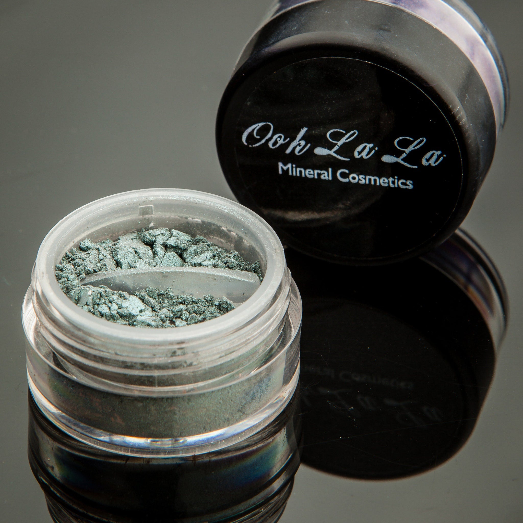 Close-up of vibrant green mineral eye shadow palette showing rich pigmentation and smooth powder texture