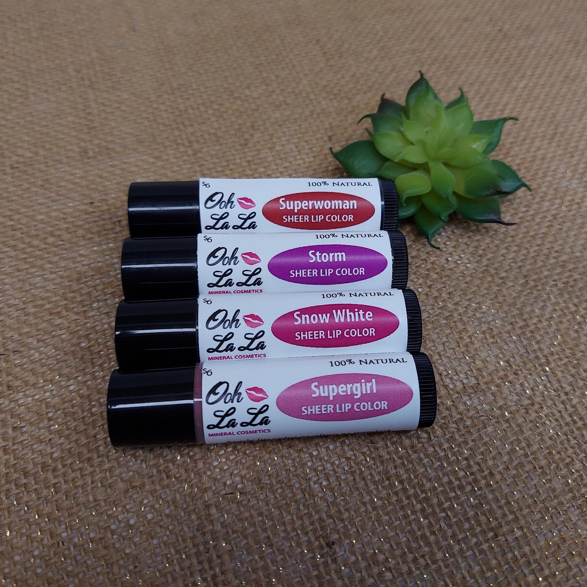 Sheer lip color tubes with black caps, white labels, and Ooh La La Minerals branding