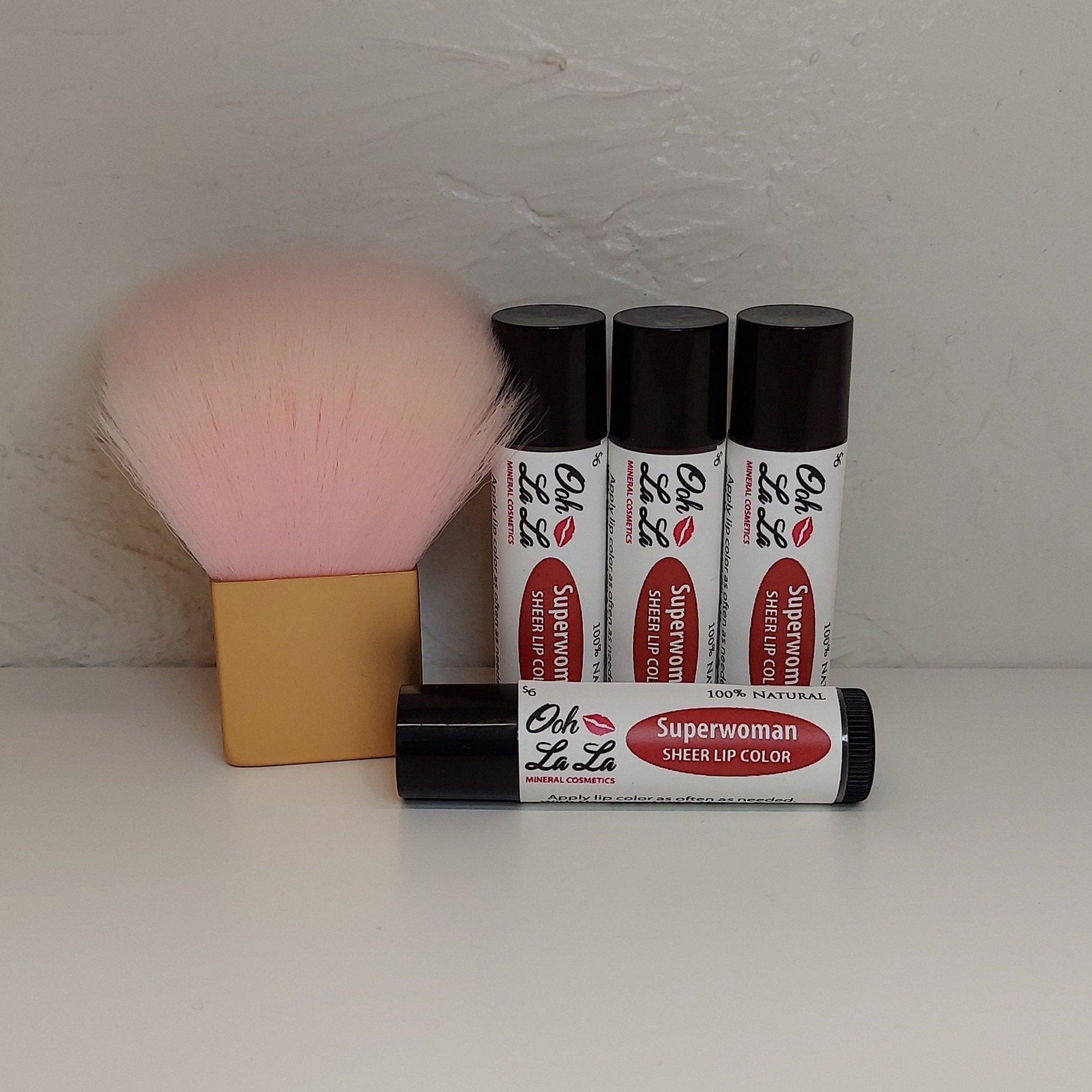 Lip color tubes with black caps, white labels, and red text, Ooh La La Minerals brand