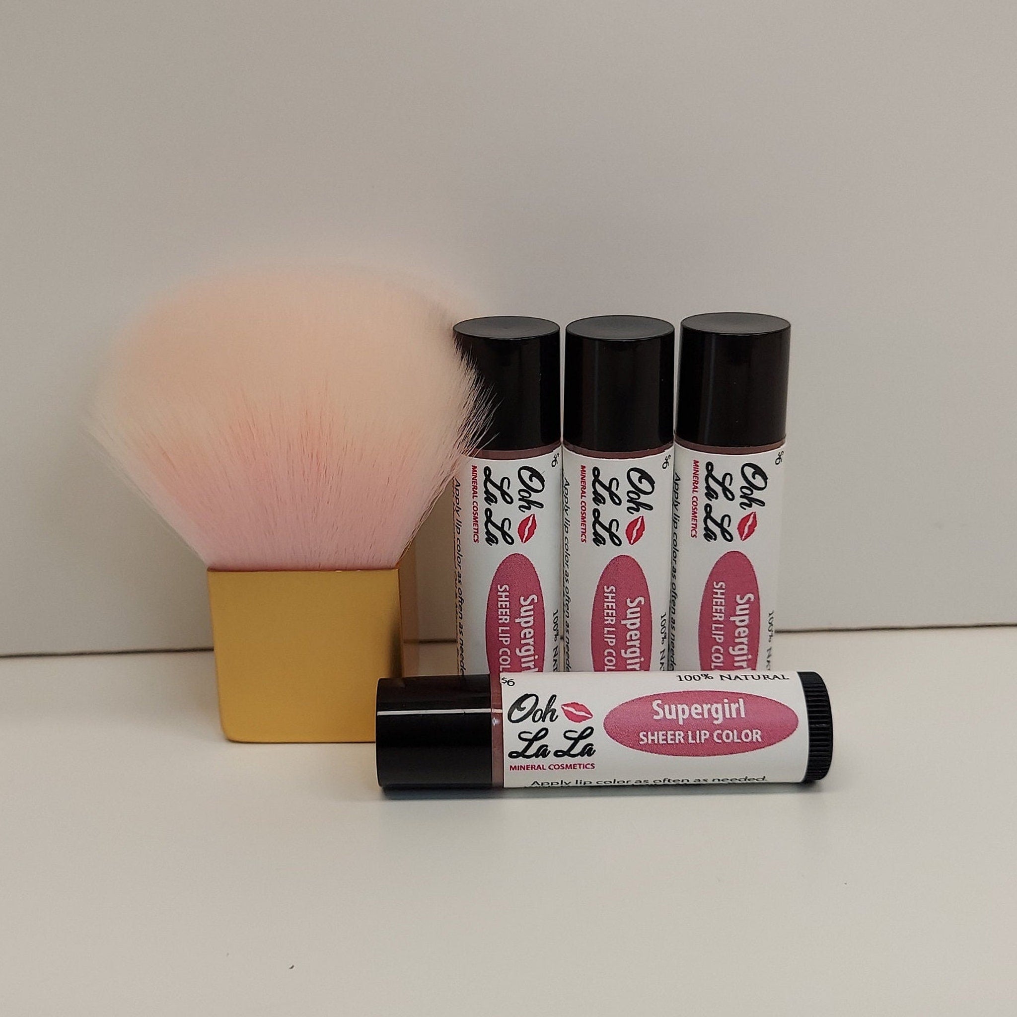 Lip color tubes with black caps, pink and white label, and Ooh La La Minerals branding