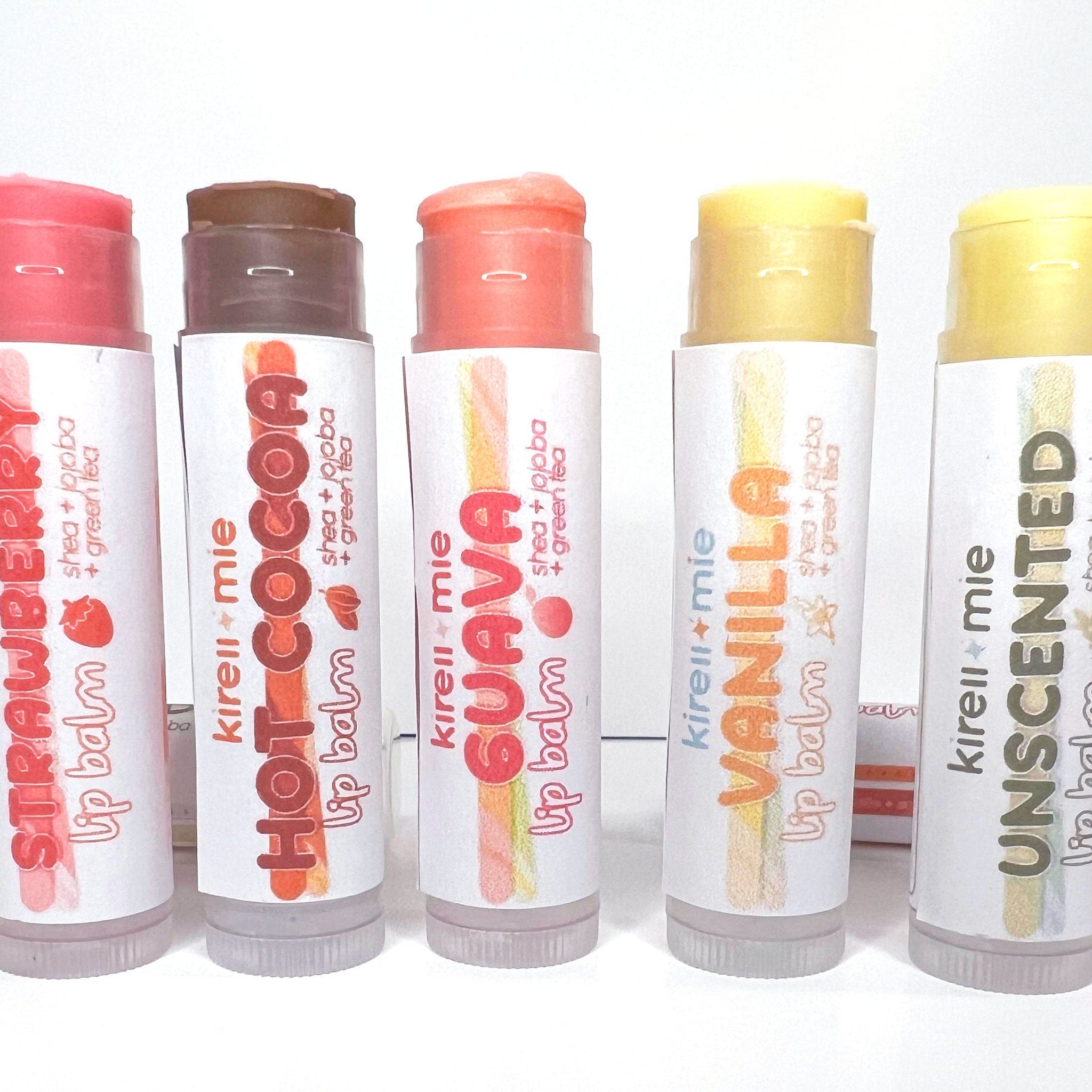 Lip balms with colorful balm, white label, and Kireiimie branding visible on packaging