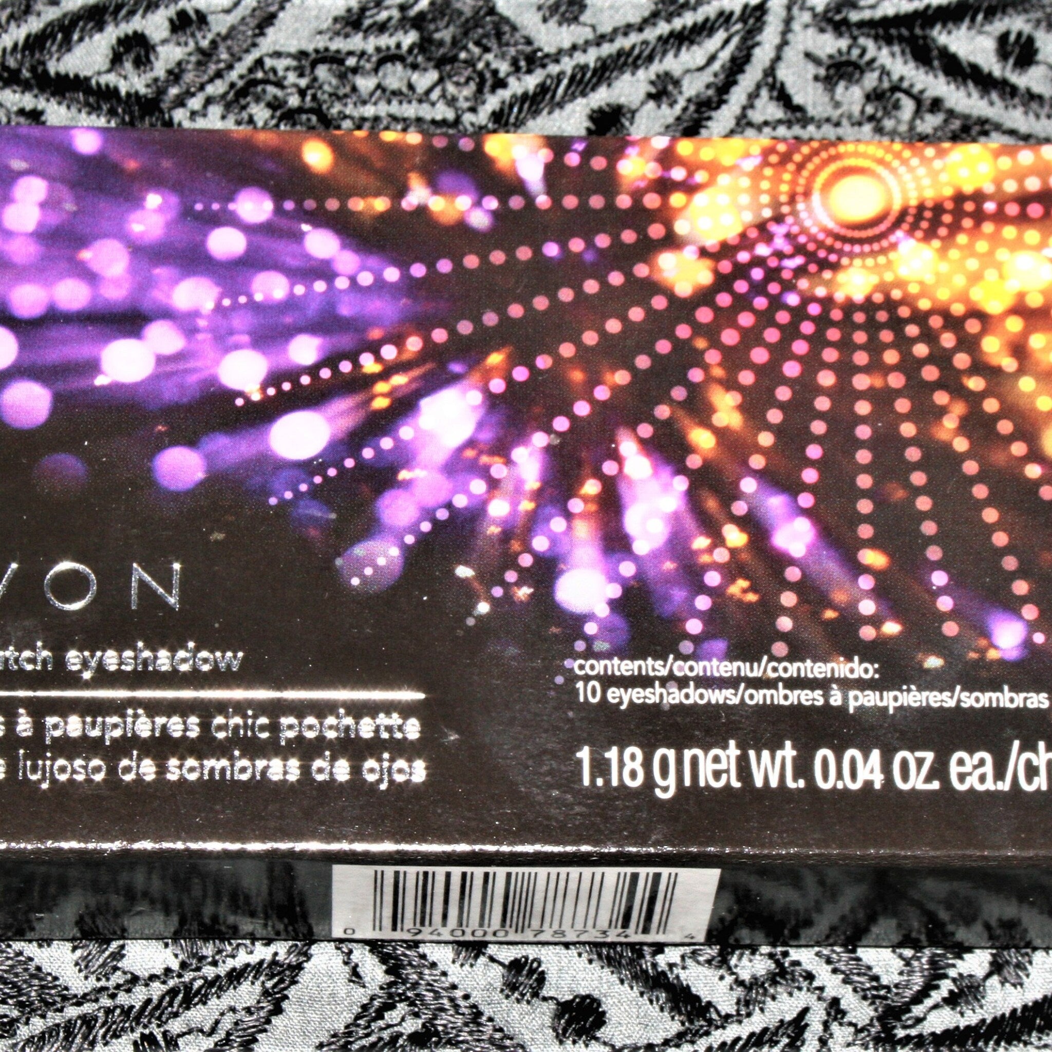 Side view of vintage Avon Luxe clutch eyeshadow compact showing gold-trimmed edges and textured surface