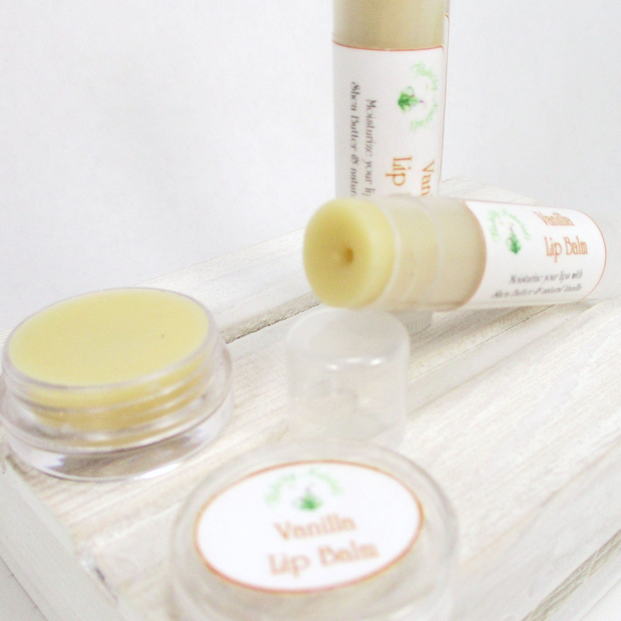 Lip balm with yellow color, clear container, and "Vanilla Lip Balm" label on white surface