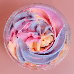 Side view of golden jar with whipped mango shea butter, showcasing rich texture and passionfruit scent details
