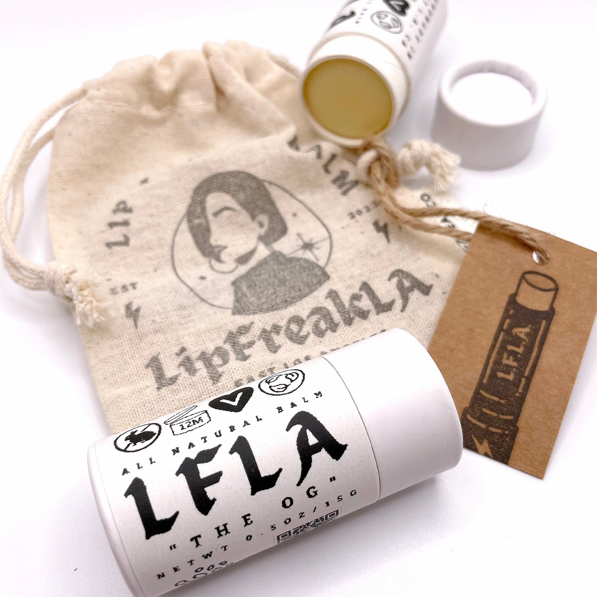 Lip balm with white tube, beige drawstring bag, and brown tag with LFLA logo