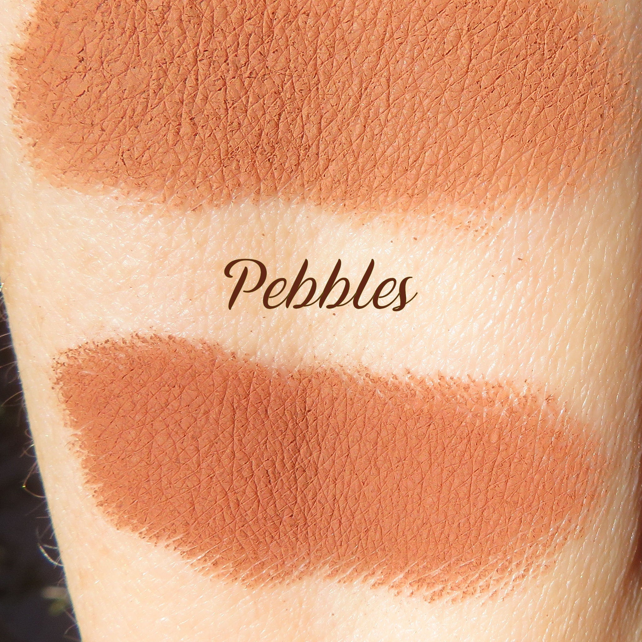 Swatch of matte medium orange-brown mineral eye shadow with smooth mica finish on fingertip