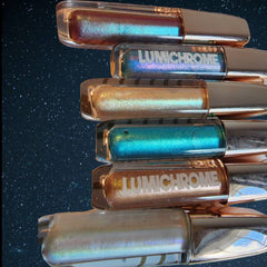 Lip gloss tubes with iridescent color, metallic lids, and "LUMICHROME" text visible